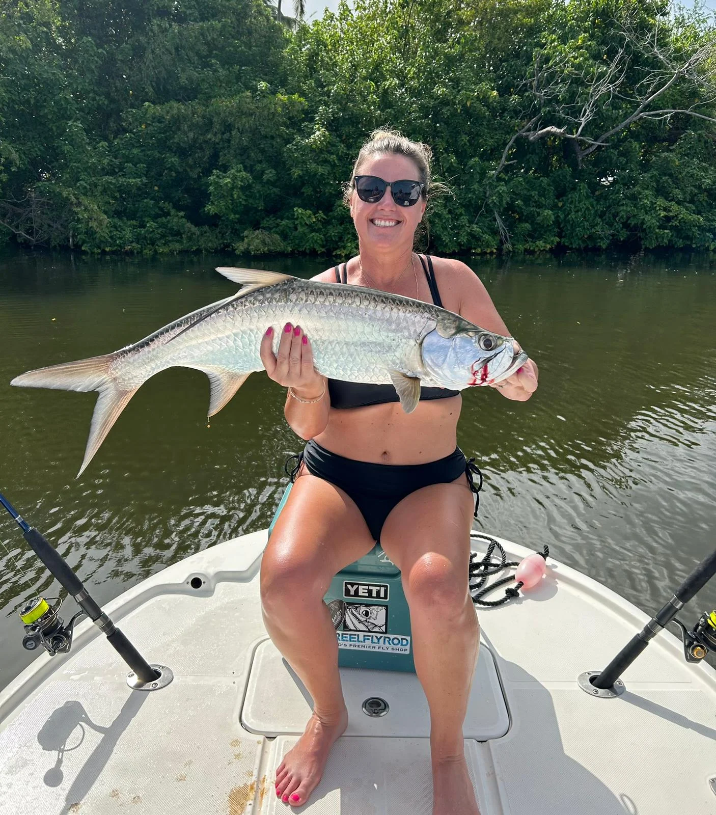Guest angler holding her tarpon